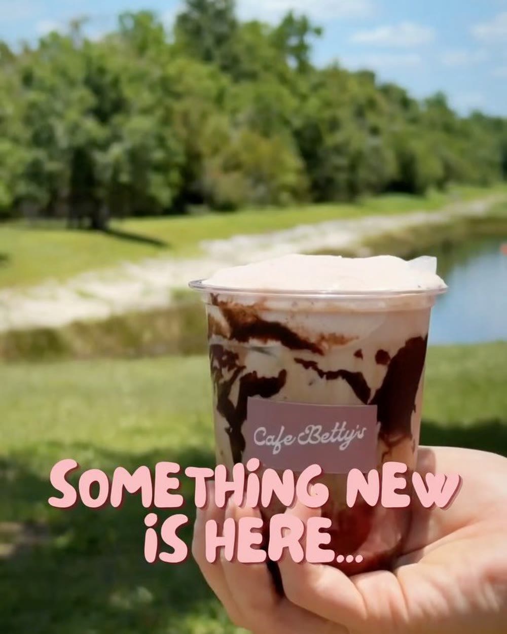 A marbled mocha held up against a Florida lake — “something new is here”