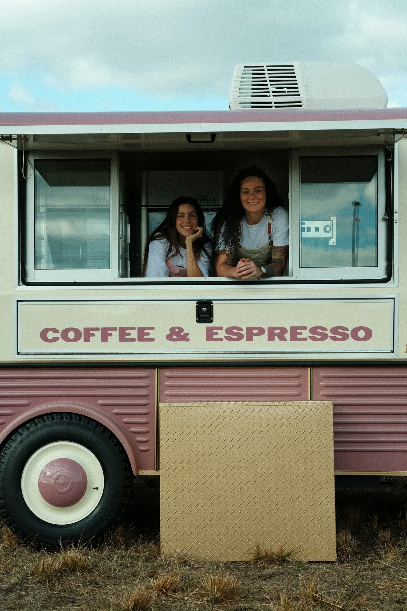 Kristen and Berkley leaning out of the Cafe Betty's serving window